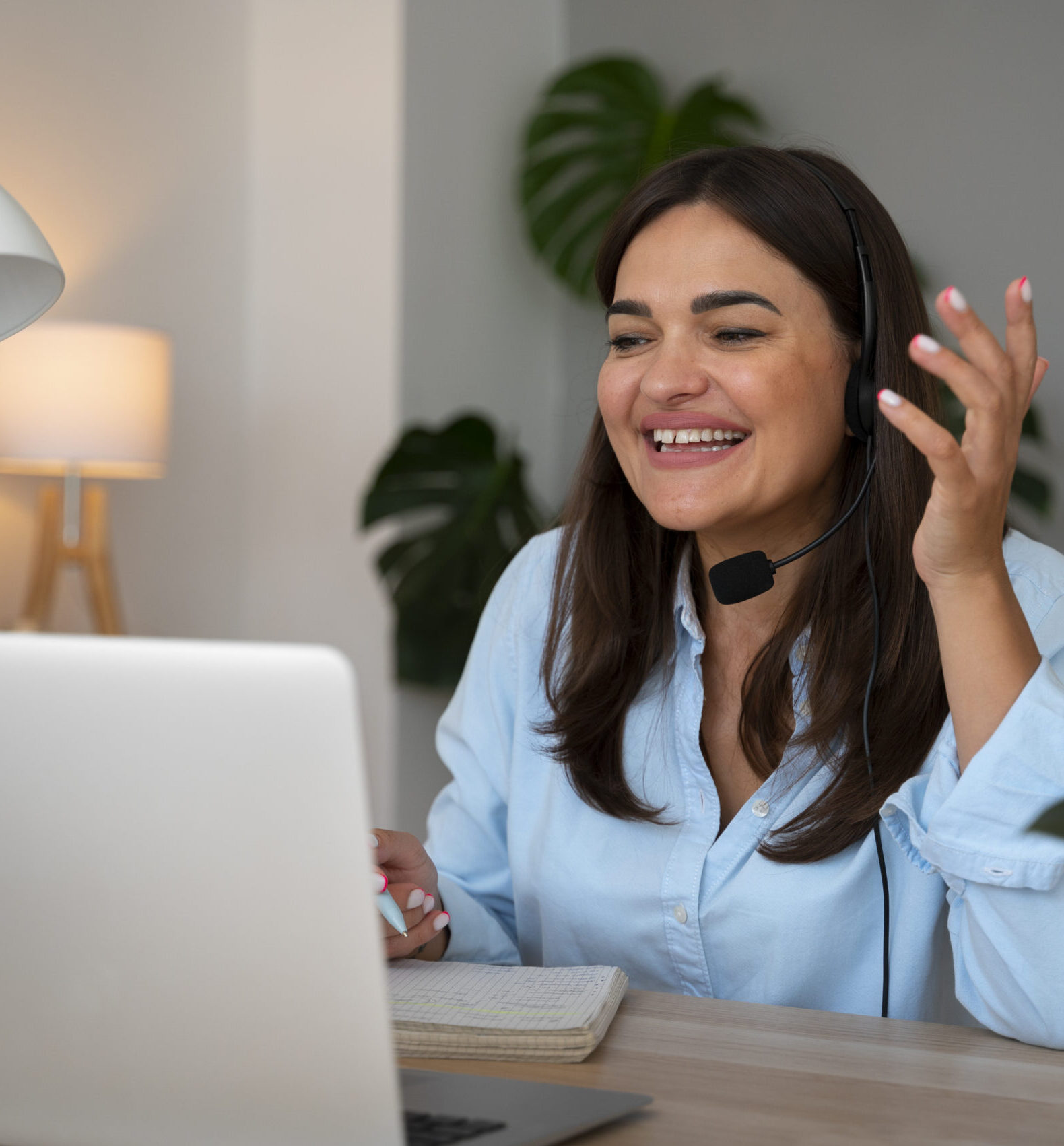 woman-having-video-call-home-laptop-with-headset